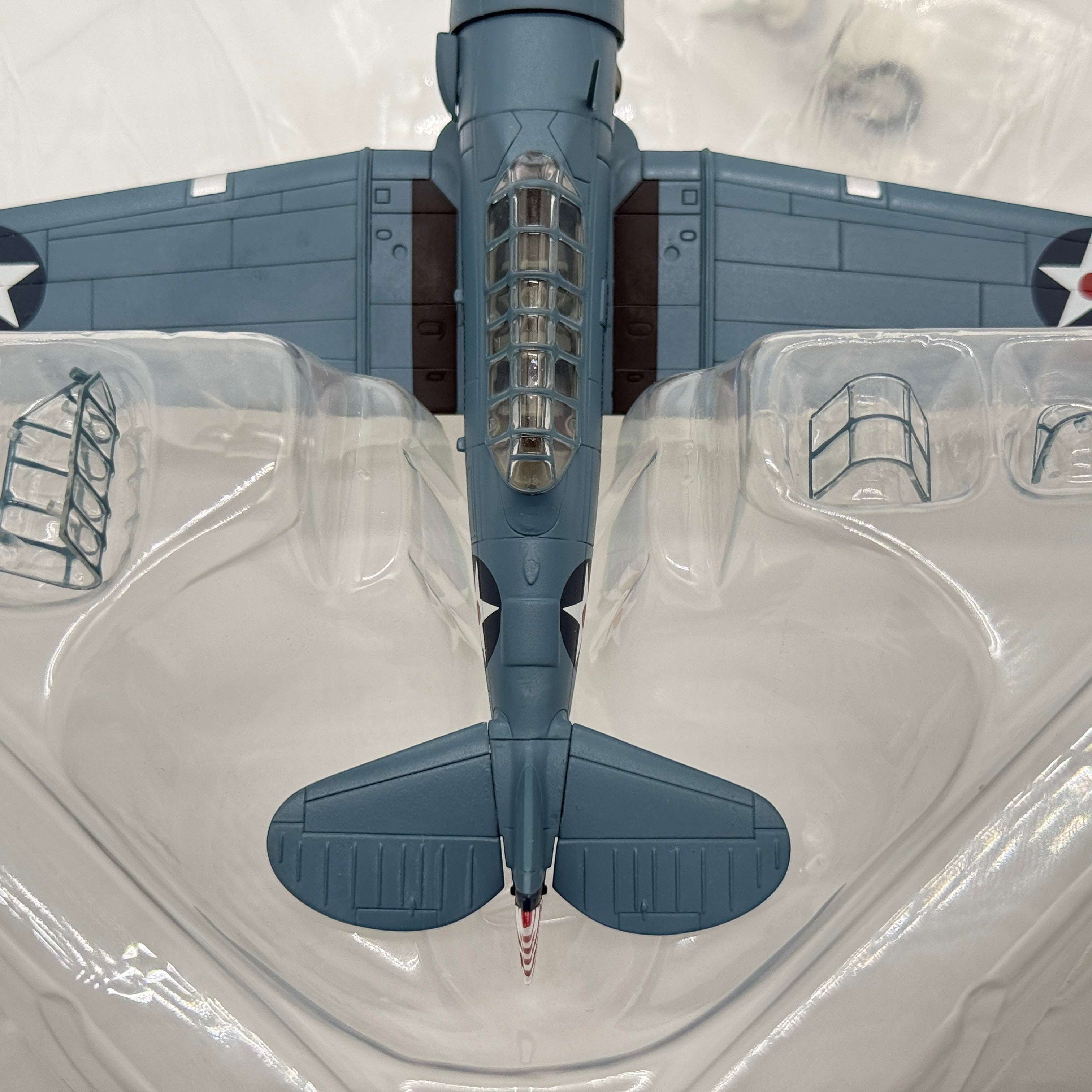 The Collectables Vault 1:72 scale diecast North American SNJ-3 Texan model in blue-grey USMC livery, top-down view.